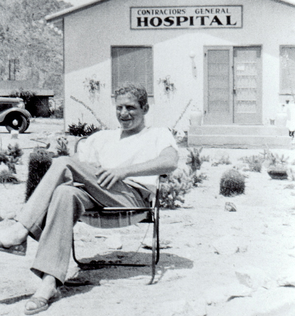 Dr. Sidney Garfield sits in front of Contractors General Hospital in 1935.