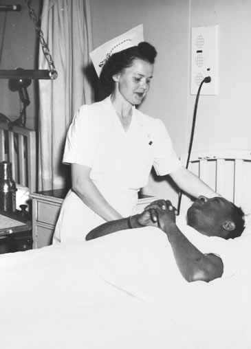 Nurse attending shipyard worker, Oakland hospital, circa 1943
