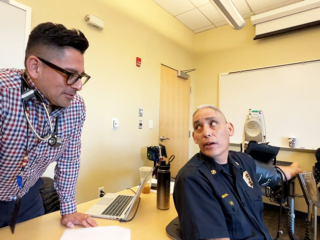 Felipe Hernandez, MD, worked with Denver firefighters during a screening event at Station 26 in January 2023.