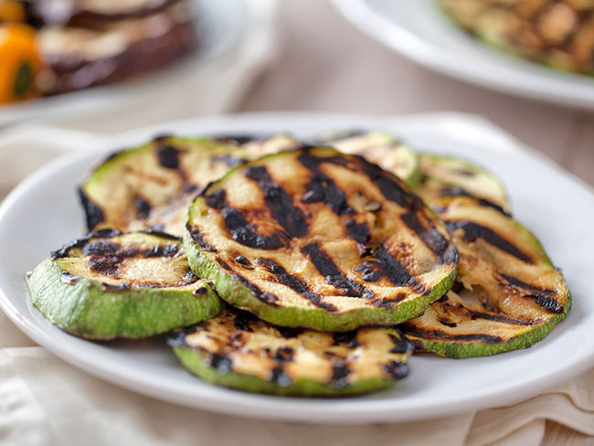 Plate with round slices of zucchini striped with grill marks